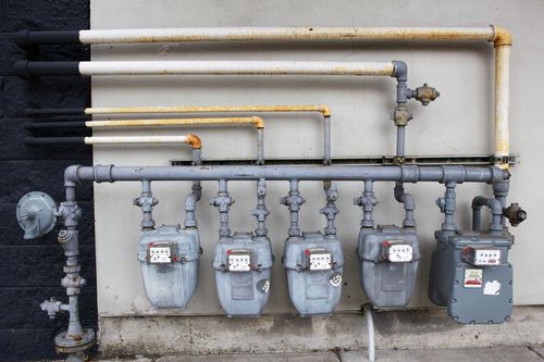 Image is of several water meters outside of building, concept of Southwest Ranches commercial plumbing