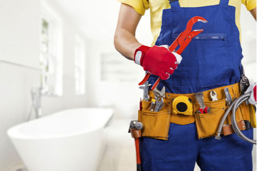 Plumber standing in bathroom, concept of Hollywood plumbing services